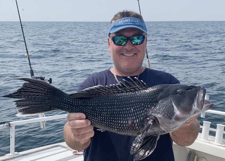 A main holding a sea bass