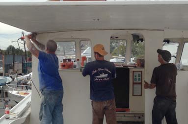 Capt. Steve and two men from T&S Marine cutting off the back of the deckhouse.