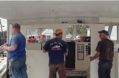 Capt. Steve and two men from T&S Marine taking off the back of the deckhouse.