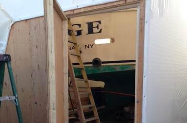 Open backdoor entrance to giant tent that will house the boat while it's being worked on during the cold winter months