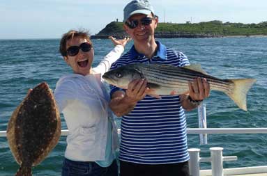 Both Sergey and Anastasia smiling big into the camera, while Anastasia holds her fluke and Sergey holds his bass.
