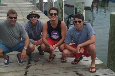 The crew back at the marina are all smiles afas they bend down next to their catch.