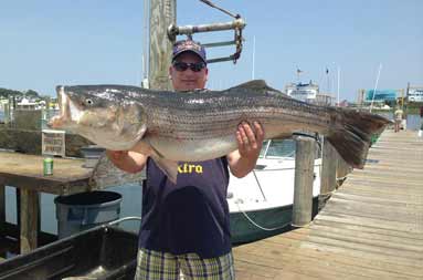 One of the guys back at the marina holding a large bass he caught