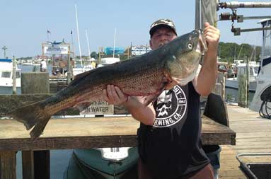 Another one of the guys back at the marina holding up the large bass he caught