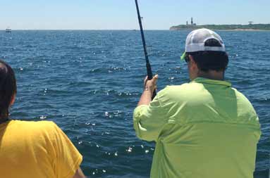 Close up of one of the guys reeling in a fish