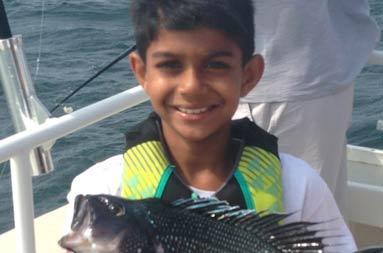 One of the kids holding up his scup