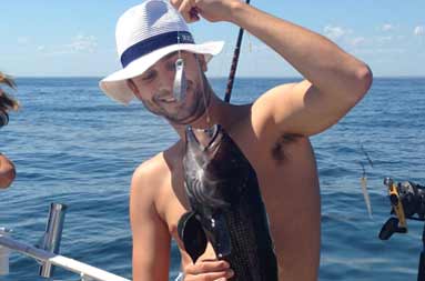 One of the adults guys holding up the porgy he caught