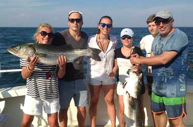 Group shot of the 6 guests with their striped bass
