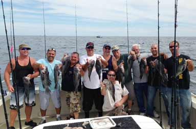 The group poses with their catch of bass.
