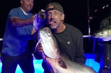 One of the guys holding up the bass he caught