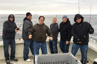 Group shot of everyone smiling on the boat.