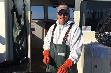 Captain Steve on the boat at the fillet board cutting up some fish