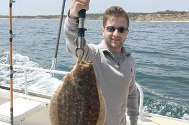 A second guy holding up a fluke.