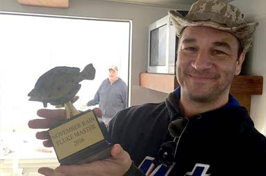 One of the guys, George, displaying a mock award he made for November Rain that says 'November Rain Fluke Master 2016.'