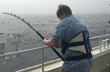 One of the guys, Luke, strapped into a harness fighting a shark.