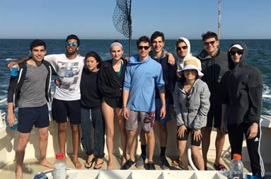 Group pic of the 10 young women and men aboard the boat.