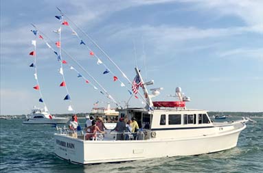 The NRC at sea decorated with the American flag and red, white and blue banners.